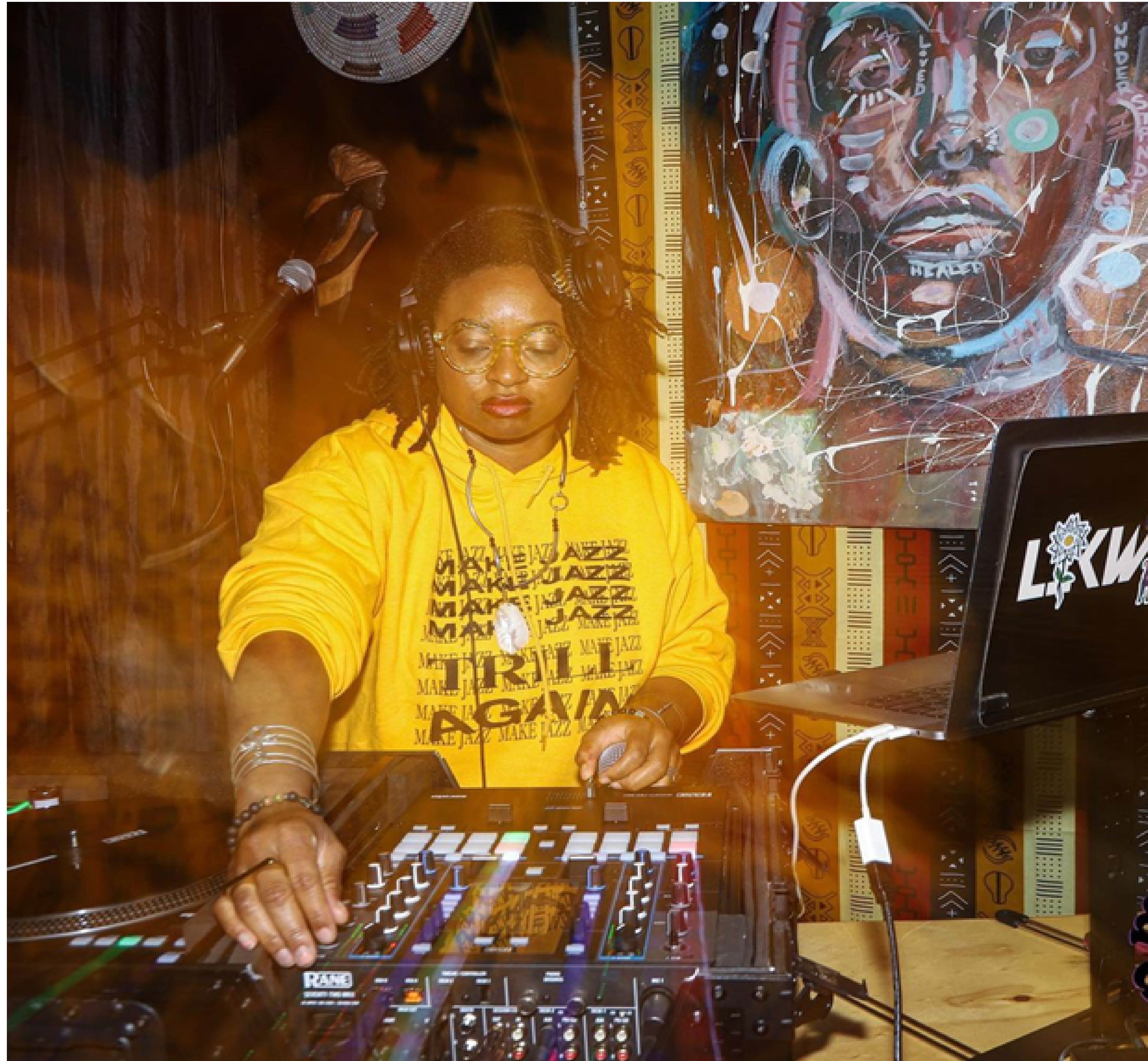 DJ LiKWUiD djing at a table.